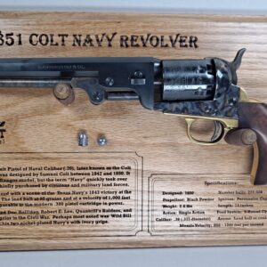 Engraved historical handgun showcased on oak board